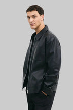 LEFT SIDE POSE Men's black leather jacket made from premium full grain leather with front zipper closure, classic collar, and modern minimalist design by LEATHERTEXEU.