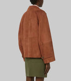 Women's Signature Suede Pea Coat in premium brown suede featuring a double-breasted design, wide lapels, relaxed fit, and elegant contemporary styling